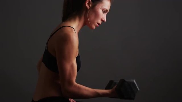 Strong healthy mixed race woman lifting weights