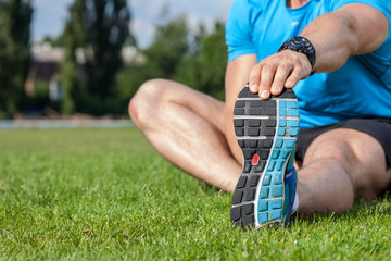 Young healthy athlete is warming up in stadium