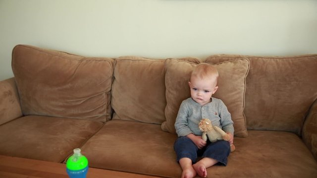 cute toddler boy watching movie on a tablet