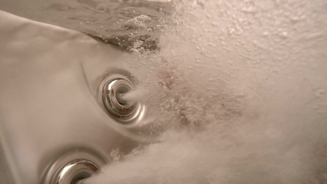 spa with bubbles and hand in slow motion