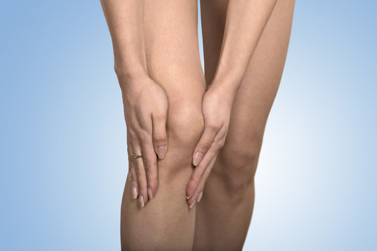 cropped image woman hands touching painful leg knee