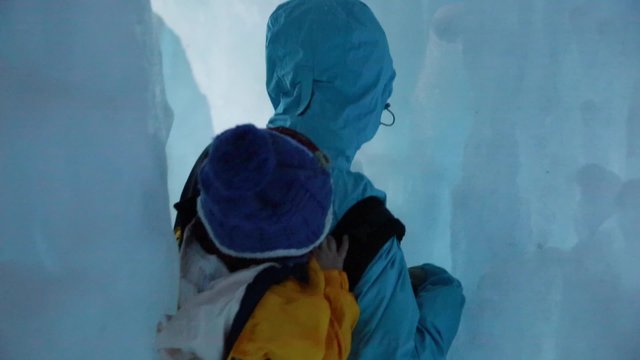 a mother and baby in an ice tunnel