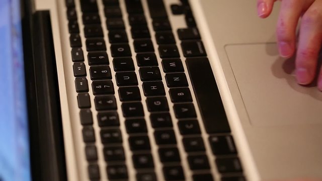 Closeup hand using a laptop computer
