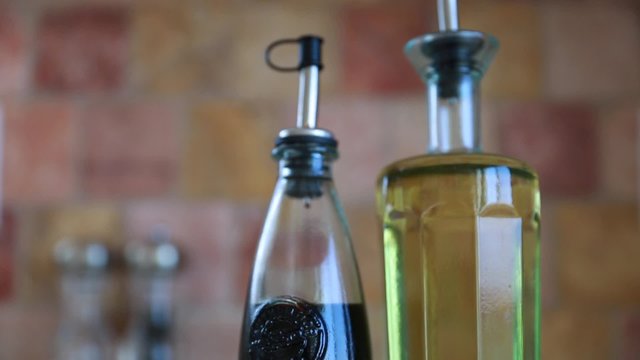 a glass bottle with olive oil and balsamic vinegar