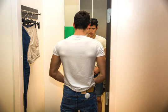 Young Man Trying on Clothes in Clothing Store
