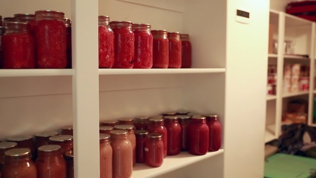 canned food in jars in storage shelf