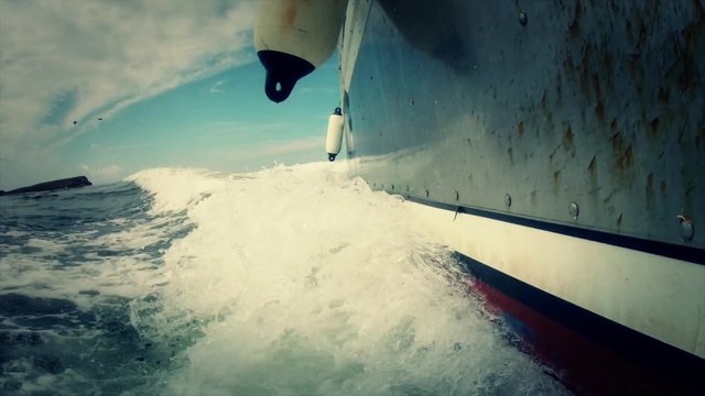 a low shot of large fishing boat on traveling across the ocean