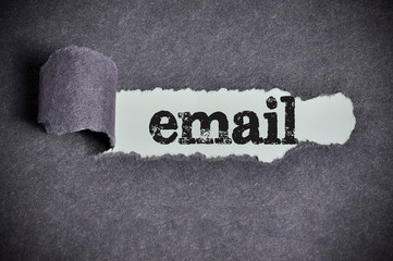 email word under torn black sugar paper