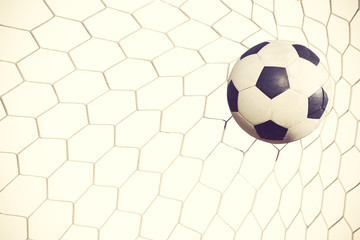 soccer ball in goal on white background vintage color