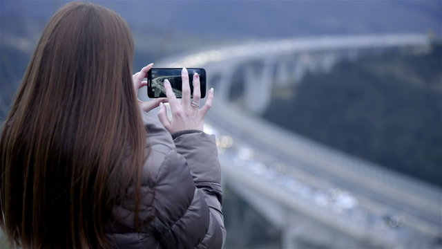 Person video recording traffic jam with smartphone