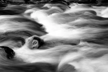  Fast flowing water over rocks in stream © Stillfx