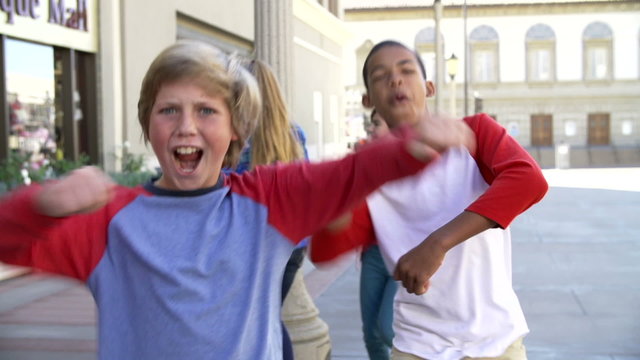 Group Of Teenage Children Posing For Camera In Slow Motion