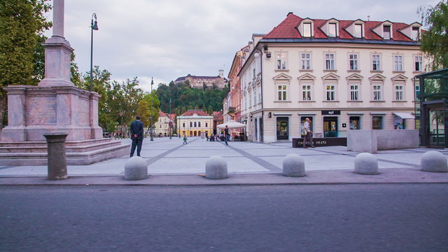 Driving by Kongresni trg with Ljubljana castle in background in slow motion