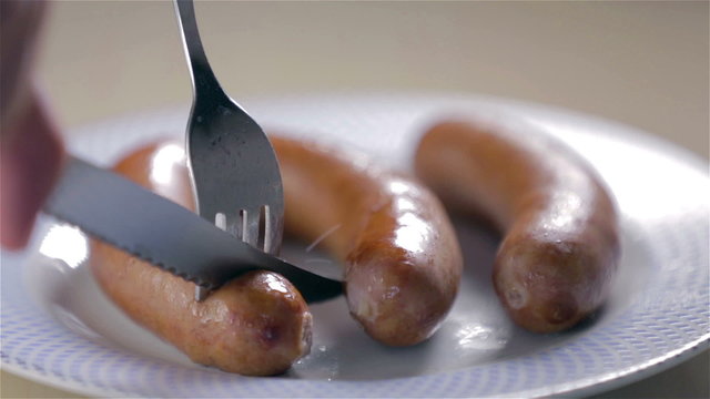 Cutting sausage close up