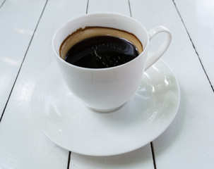 white coffee cup on wooden background