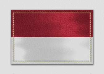 Monaco flag leather label on a white leather background,vintage