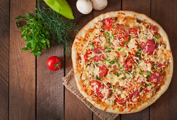 Pizza with salami, tomatoes and mushrooms