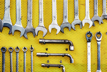 Neat arrangement of tools on yellow pegboard