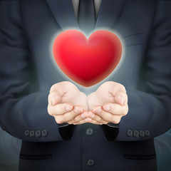businessman holding red heart symbol
