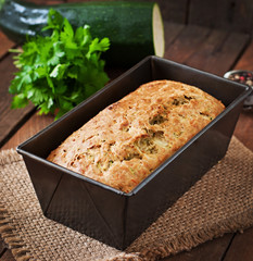 Zucchini bread with cheese on a wooden background