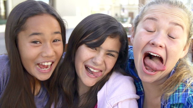 Three Teenage Girls Posing For Camera In Slow Motion