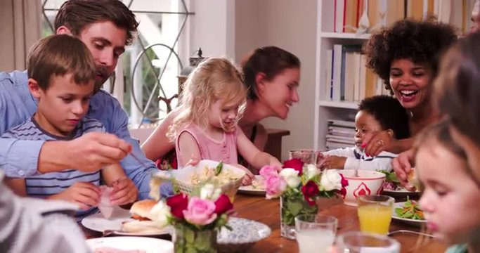 Group Of Families Having Meal At Home Together