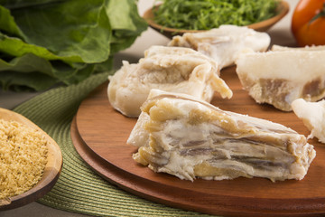 Raw pig tails on wooden background