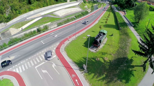 Flying over locomotive statue next to road