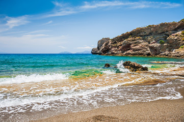 Beautiful wild beach with clear turquoise water and rocks