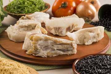 Raw pig tails on wooden background