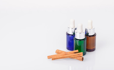 Bottles of aromatic essential oils and cinnamon sticks