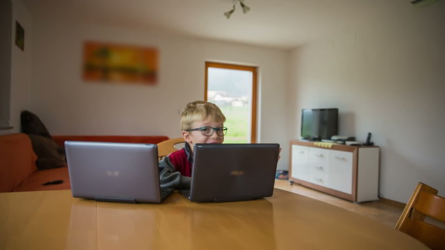 Kid on computer in living room jib shot