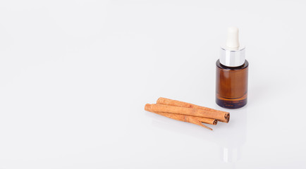 Bottle of aromatic oil and cinnamon sticks