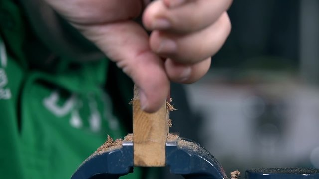 Cutting away useless parts of wooden chunk on a grip