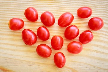 Tomatoes in heart pattern on the wood
