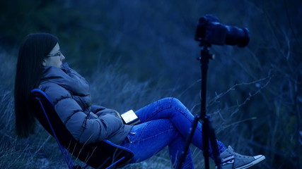 Female photographer bored making timelapse