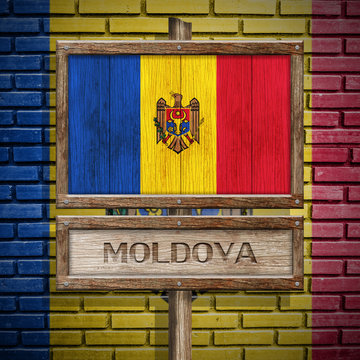 Moldova flag wooden sign with brickwall background