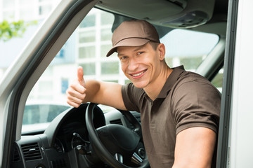 Deliverymen Showing Thumb Up Sign In Van