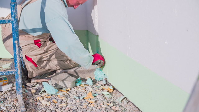Manson cutting away dried propylene from walls