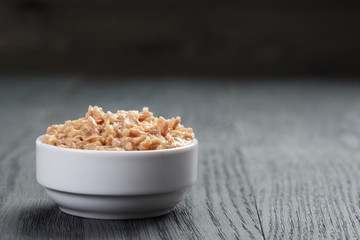 canned tuna in white bowl on wood table