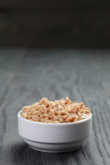 canned tuna in white bowl on wood table
