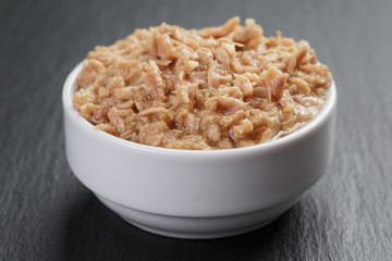 canned tuna in white bowl on slate