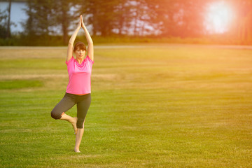 The image with a woman doing yoga in a park