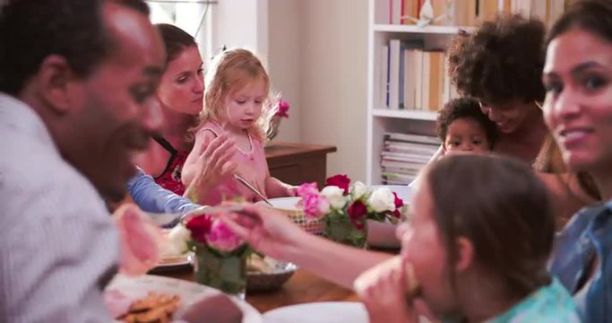 Group Of Families Having Meal At Home Together