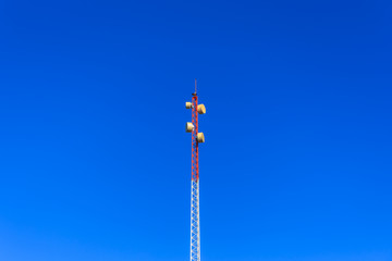 The radio tower stand in the sunshine day