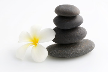 Zen stones with frangipani flower on white