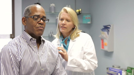 Doctor Listening To Patient's Breathing With Stethoscope