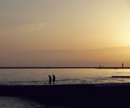 Couple walking at the beach in the evening © Alex_Po