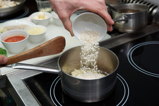 Chef is pouring rice in stewpan