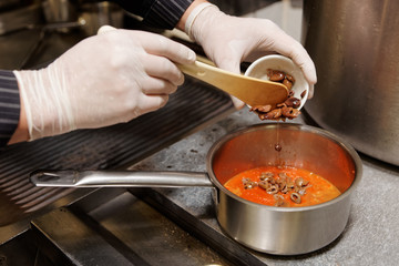 Chef is cooking the puttanesca sauce